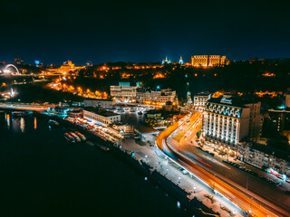 Aerial view from a drone of the embankment and the center of Kiev at night