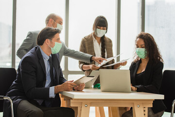 Group Businesspeople meeting in office wear medical mask protect covid19 or Coronavirus