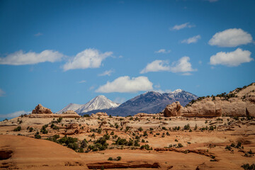 Snow-topped mountains in Colorado viewed over the top of dessert formation - Contrast