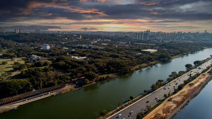 Fototapeta premium View of Marginal Pinheiros with the Pinheiros river and modern buildings in Sao Paulo, Brazil. With a place to do aquatic exercises in São Paulo