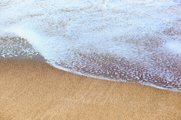 Wave of the sea on the sand beach