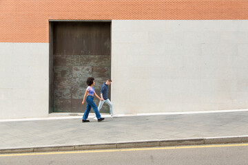 couple white man and black woman walking talking with a black iron door background 20s