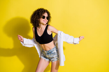 Photo of young attractive smiling happy positive good mood girl with curls dancing isolated on...
