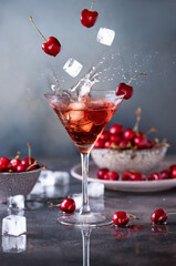 Glass of cherry juice with ice and splash