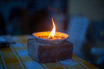 burning candle in a fireplace