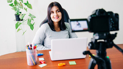 young enterprising girl, making a streming or a video to make her company known.