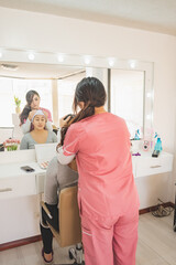 Young woman getting ready to put on makeup for a special event.
