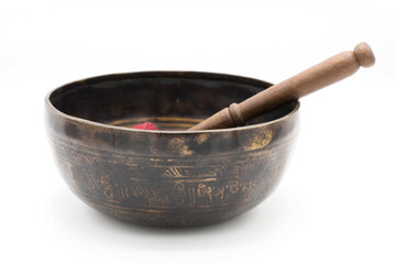 Handmade Tibetan Singing Bowl with a stick made of Dark Metal, Isolated on a White Background.