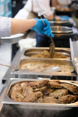 Meat dishes on the food distribution line in the self-service dining room.