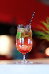 Fresh cocktail with lime, mint, raspberries and ice. Alcoholic, non-alcoholic drink-a drink at the bar in a nightclub.