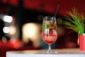 Fresh cocktail with lime, mint, raspberries and ice. Alcoholic, non-alcoholic drink-a drink at the bar in a nightclub.