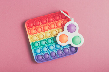 Rainbow antistress toys Pop It and Simple Dimple for the development of fine motor skills