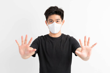 Stop Civid-19 , Asian man wearing Face Mask show stop hands gesture for stop corona virus outbreak , protect spread Covid-19 Coronavirus concept