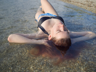 Woman Sunbathing in Water