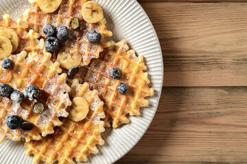 blueberry waffles on a wooden background