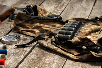 Various hunting equipment on old wooden background