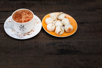 cup of hot chocolate and small Brazilian cheese breads, healthy food