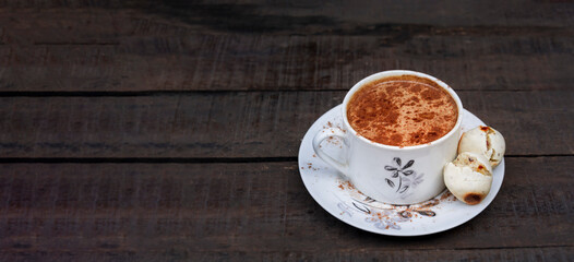 cup of hot chocolate with small vegetarian cheese breads, healthy Brazilian food with space for text