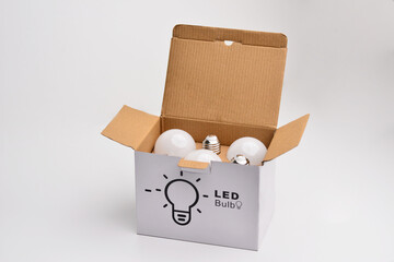 Carton box with led light bulbs on a white background. Packing for bulb and led bulb over view....