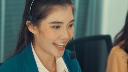 Businesswoman wearing headset working actively in office . Call center, telemarketing, customer...