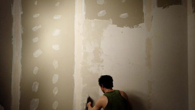 Man doing repairs. worker applies with construction putty to the wall. working process timelapse