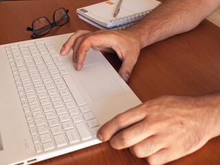 Unemployed man hands looking for work in the network and online training