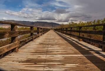 Wooden path bridge at Mediterranean sea overview, sunset summer evening