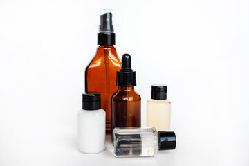 Brown and transparent bottle for liquid cosmetic serum and cream in a jar