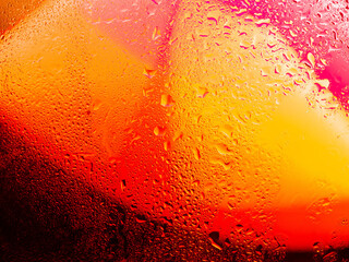 Misted glass, colorful abstract rainbow colored mist rain drops dew drops water droplets condensation on rainbow tinted glass window