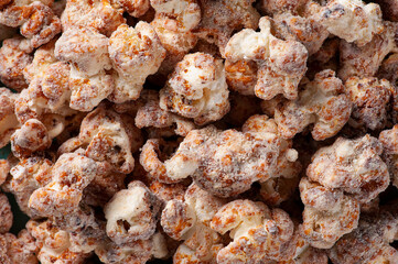 Gourmet sweet popcorn in close-up photo. Caramel flavor. Top view