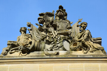 Sculpture with military attributes on the roof of the building