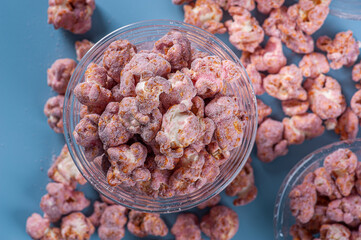 Gourmet sweet popcorn in plastic cup. Strawberry flavor. Top view