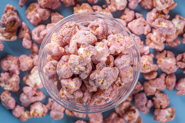 Gourmet sweet popcorn in plastic cup. Strawberry flavor. Top view