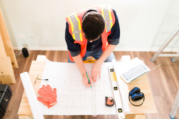 High angle of a contractor working at his desk