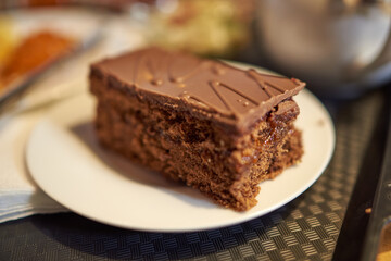 Piece of chocolate pie with icing and filling. Blur, bokeh