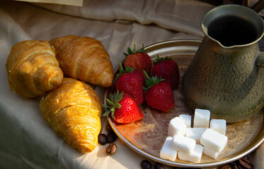 Breakfast with strawberries, croissant   and coffee on wooden table