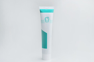 Toothpaste container on white isolated background. Refreshing and whitening toothpaste. Close up of a toothpaste tube on white background.