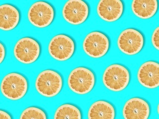 Creative look of sliced ​​orange rings on a pastel blue background. Minimal concept of summer...