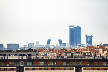 View of the Kio towers and the four Business Area Towers next to Plaza de Castilla on a cloudy day...