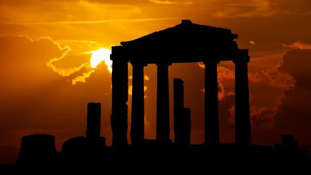 Gate of Athena Archegetis in Roman Agora of Athens, Time Lapse at Sunset with Red Sun and Fiery Sky, Greece