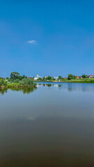 Landscape with a lake and clouds in the sky in the summer season