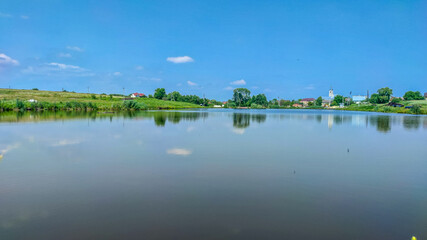 Landscape with a lake and clouds in the sky in the summer season