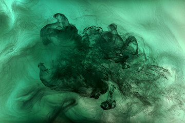 Green smoke cloud underwater background. Abstract swirling ocean, vibrant emerald color silk....