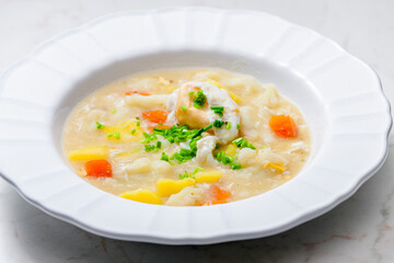cauliflower soup with carrot, potatoes and poache egg