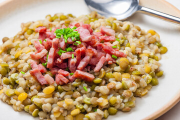 porridge of legumes with fried bacon and chive