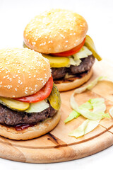 homemade hamburger with pickled cucumber and tomato