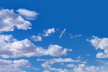 Sky with clouds with a airplane flying upward