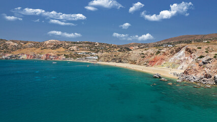 Obraz premium Aerial drone photo of scenic colourful volcanic rocky bay and emerald sandy beach of Paleochori a natural vacation paradise with resorts and water sport facilities in island of Milos, Cyclades, Greece