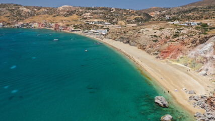 Aerial drone photo of scenic colourful volcanic rocky bay and emerald sandy beach of Paleochori a natural vacation paradise with resorts and water sport facilities in island of Milos, Cyclades, Greece