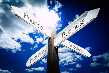 Finance, business, economy, trading concept - signpost with four arrows